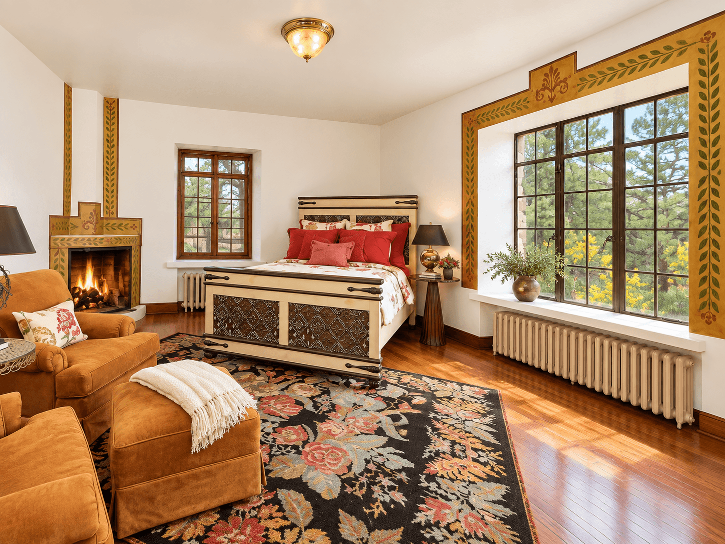 Cozy bedroom with a vintage bed, warm decor, and large windows.