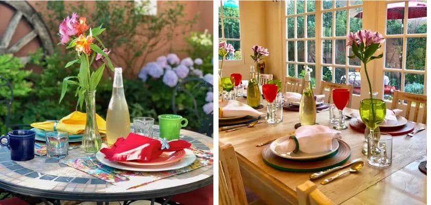 A beautifully arranged outdoor dining table with colorful plates and flowers alongside a cozy indoor dining setup.